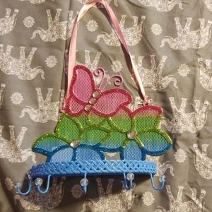Butterfly jewelry holder hangs on pink string